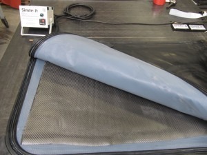 Self-heating reusable vacuum bags for composites